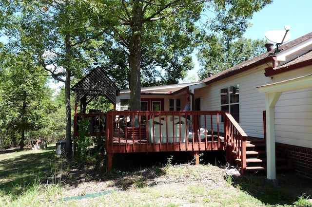 back of property featuring a wooden deck