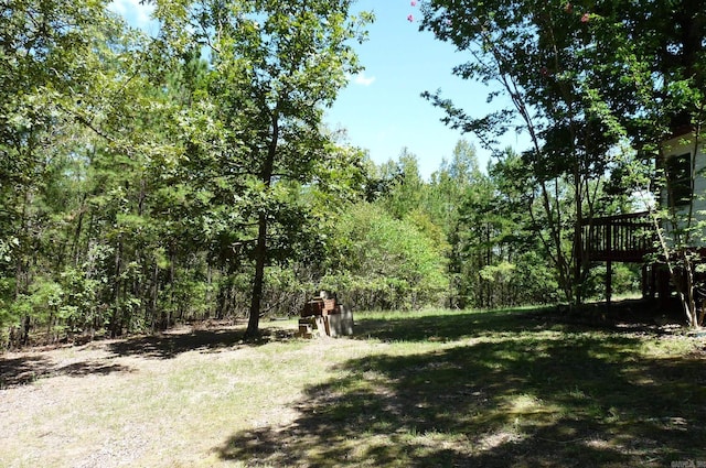 view of yard with a view of trees