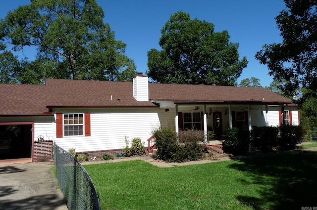 ranch-style house featuring a ceiling fan, a chimney, covered porch, fence, and a front yard