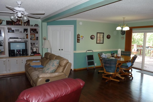 living room with ornamental molding, ceiling fan with notable chandelier, a textured ceiling, and wood finished floors