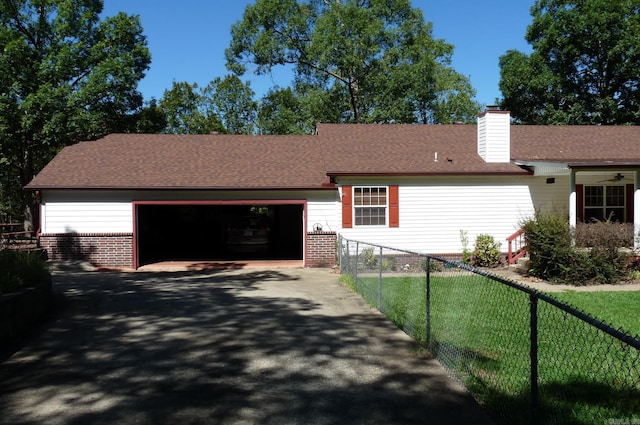 ranch-style house featuring an attached garage, brick siding, fence, driveway, and a chimney