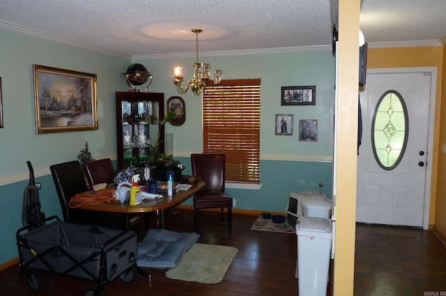 dining room featuring a textured ceiling, wood finished floors, baseboards, an inviting chandelier, and crown molding