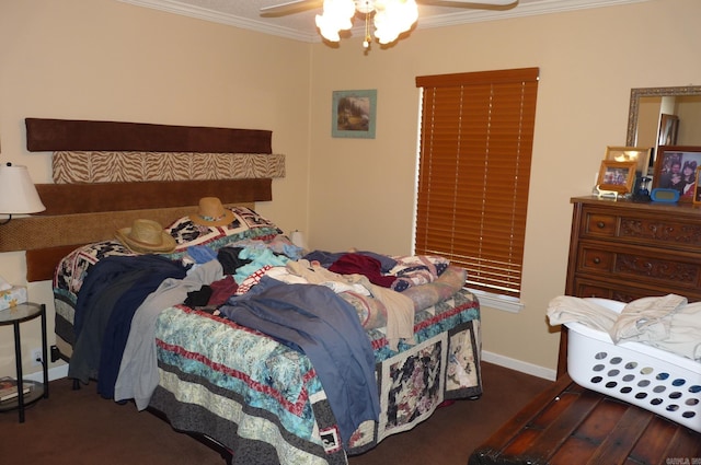 bedroom featuring a ceiling fan, baseboards, crown molding, and wood finished floors