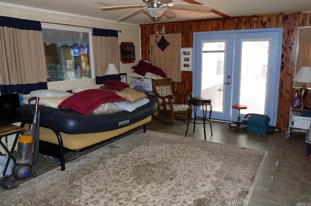 bedroom featuring wood walls, ornamental molding, and french doors