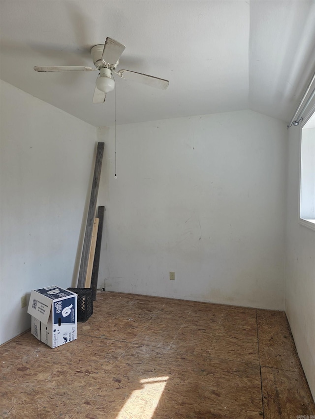 unfurnished room featuring lofted ceiling and a ceiling fan