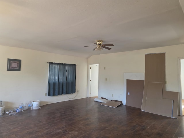 spare room with lofted ceiling, wood finished floors, and a ceiling fan