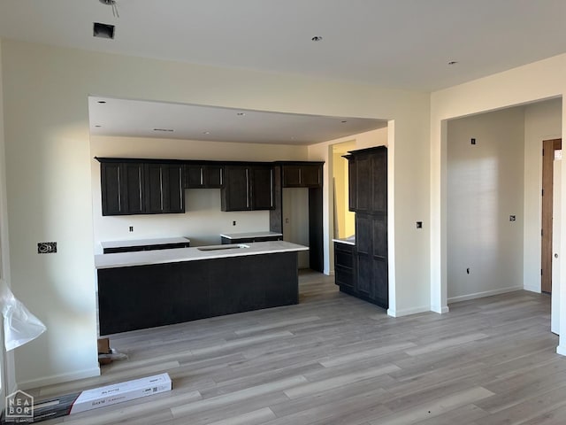 kitchen featuring light wood-style flooring and baseboards