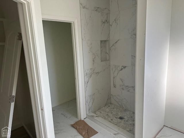 bathroom featuring a stall shower and marble finish floor