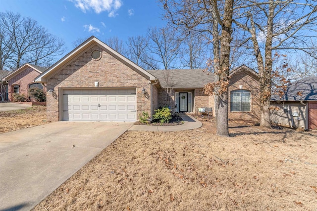 single story home with a garage, brick siding, and driveway