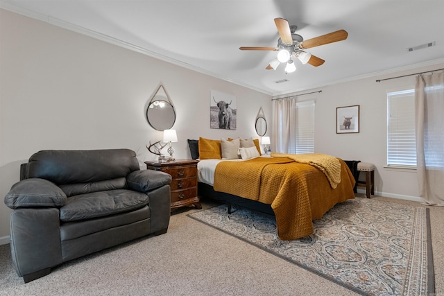 bedroom with ceiling fan, carpet flooring, visible vents, baseboards, and crown molding