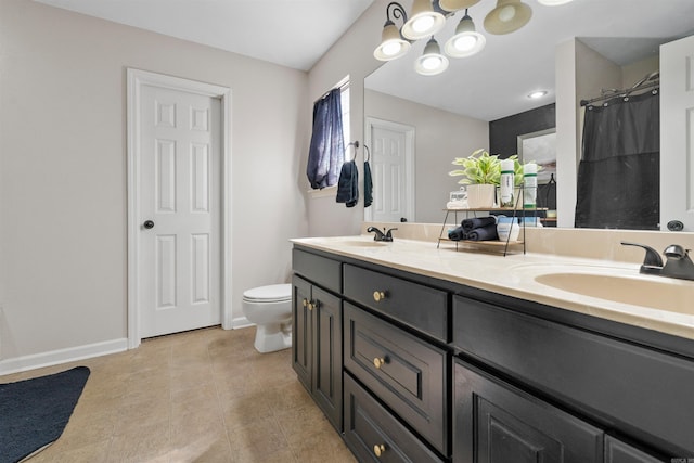 bathroom featuring double vanity, a shower with shower curtain, a sink, and toilet