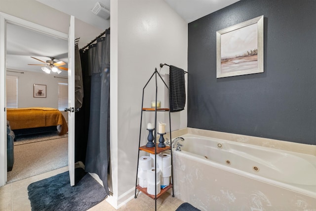 ensuite bathroom featuring tile patterned flooring, connected bathroom, a ceiling fan, a shower with curtain, and a whirlpool tub