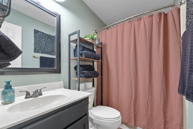 bathroom featuring a shower with shower curtain, vanity, and toilet