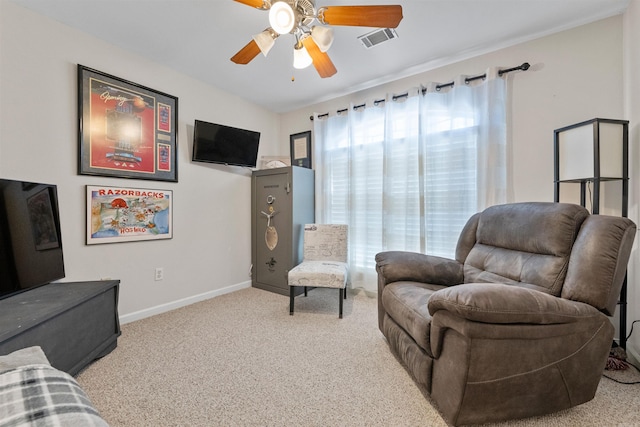 sitting room with ceiling fan, carpet floors, visible vents, and baseboards