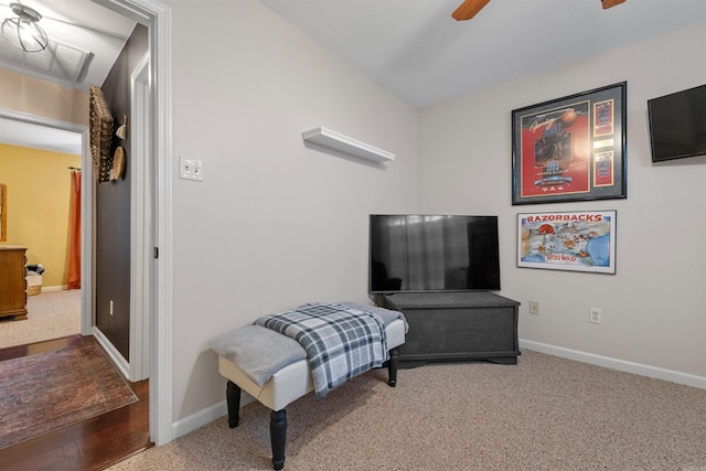 sitting room with carpet, baseboards, and a ceiling fan