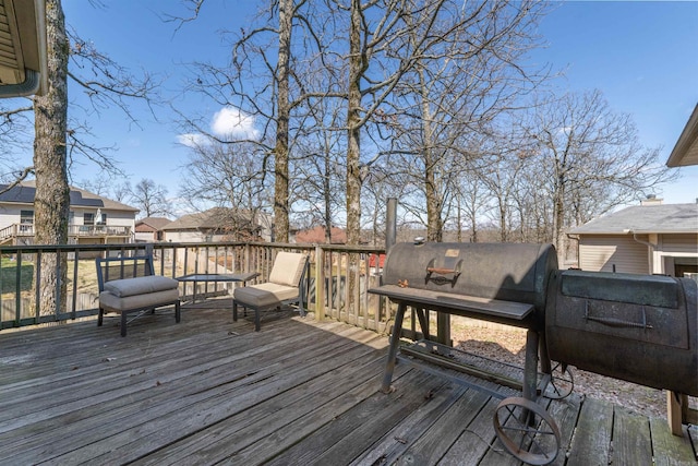 wooden deck featuring a grill