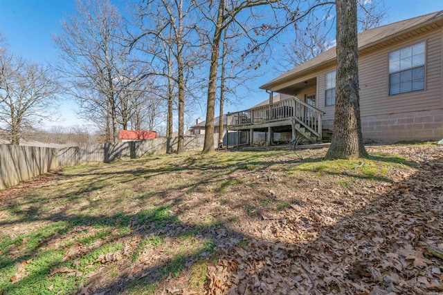 view of yard with stairs, a fenced backyard, and a wooden deck