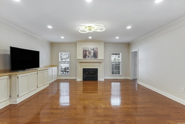 unfurnished living room featuring ornamental molding, a fireplace, and a wealth of natural light