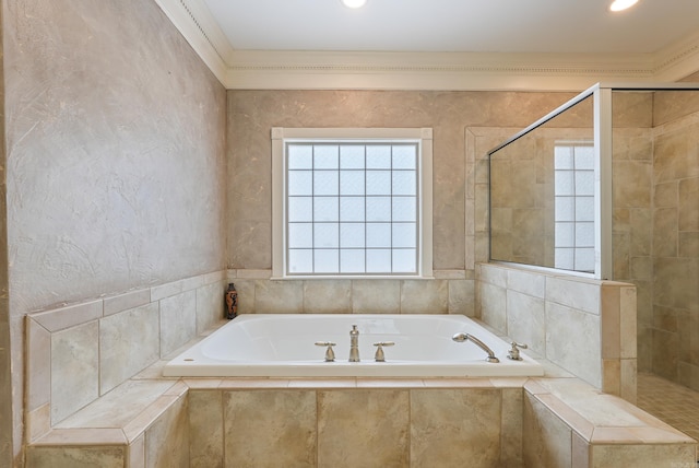 bathroom featuring a tile shower, ornamental molding, and a garden tub