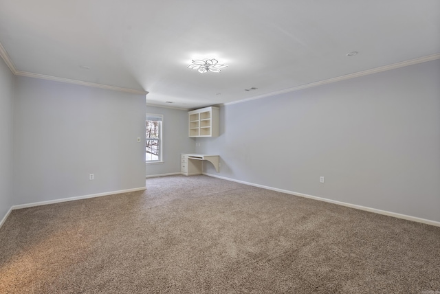 carpeted spare room featuring ornamental molding, visible vents, and baseboards