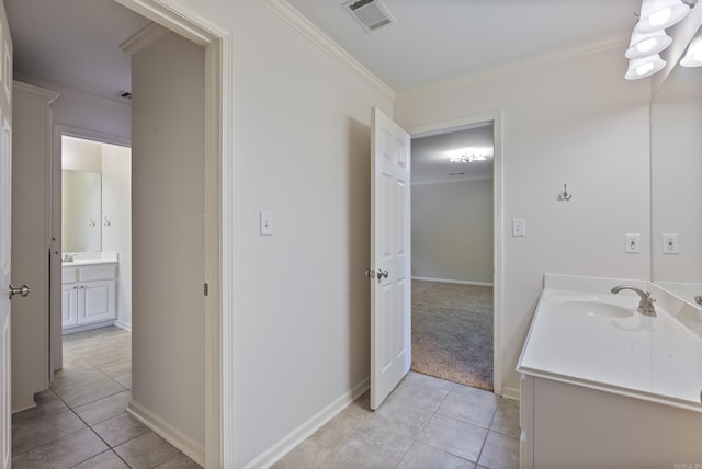 bathroom featuring visible vents, tile patterned flooring, vanity, and crown molding