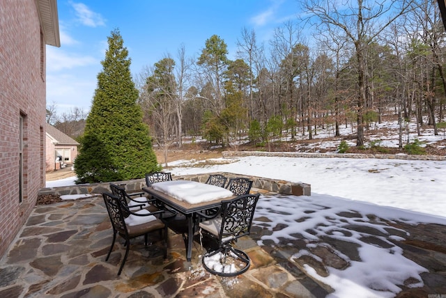 snow covered patio with outdoor dining area