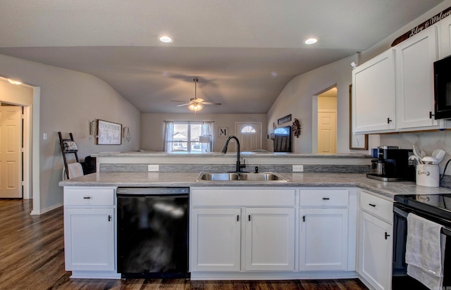 kitchen featuring white cabinets, lofted ceiling, a peninsula, black appliances, and a sink