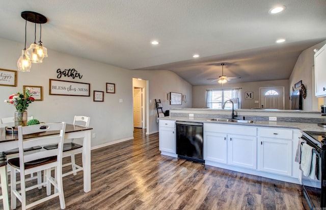 kitchen with a peninsula, black appliances, white cabinets, and a sink