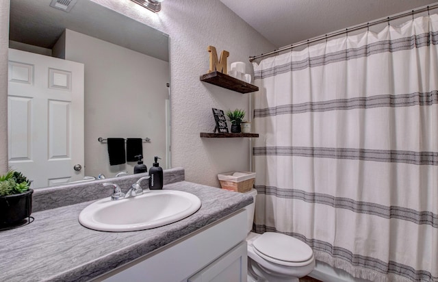 bathroom with a textured wall, toilet, visible vents, vanity, and a shower with curtain