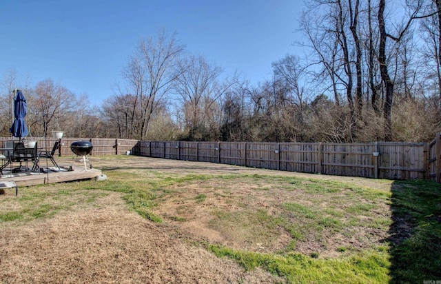 view of yard with a fenced backyard and a wooden deck