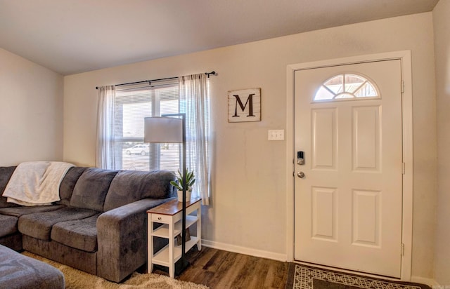 entrance foyer with dark wood finished floors and baseboards