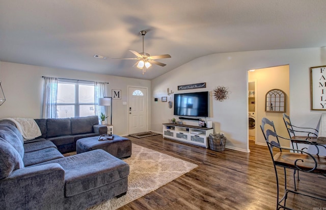 living area featuring washer / dryer, visible vents, lofted ceiling, ceiling fan, and dark wood-type flooring