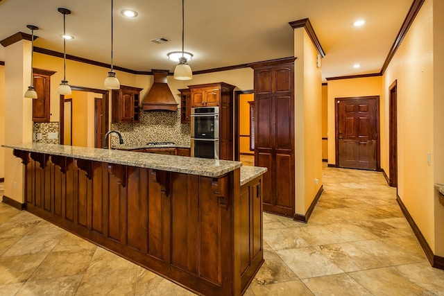 kitchen featuring visible vents, a peninsula, light stone countertops, custom exhaust hood, and stainless steel appliances