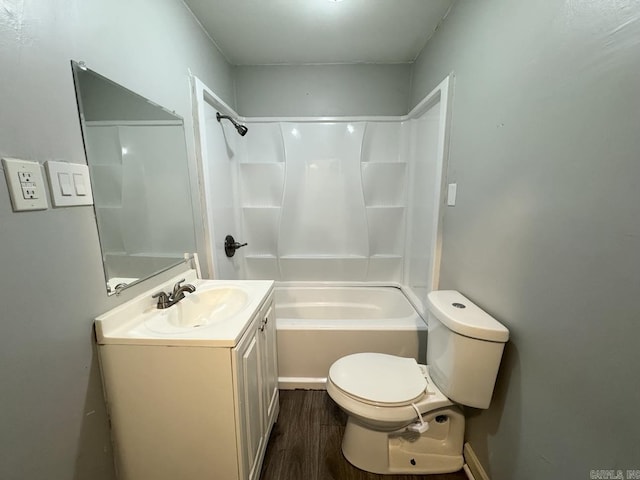 bathroom featuring toilet, washtub / shower combination, wood finished floors, and vanity