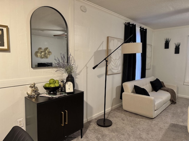 living area with a textured ceiling, ornamental molding, and carpet flooring