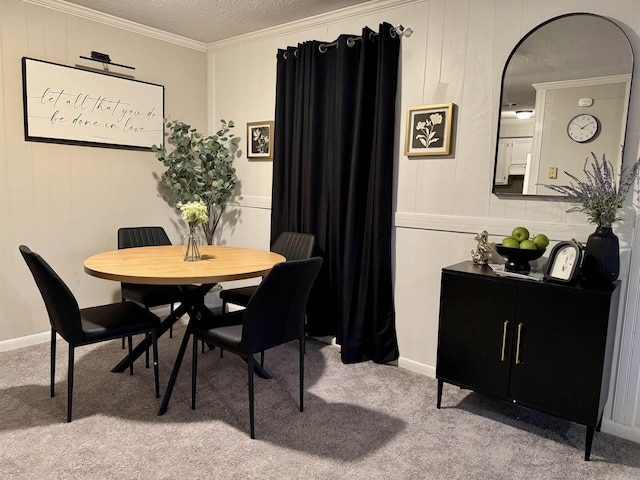 dining area featuring a textured ceiling, ornamental molding, and carpet