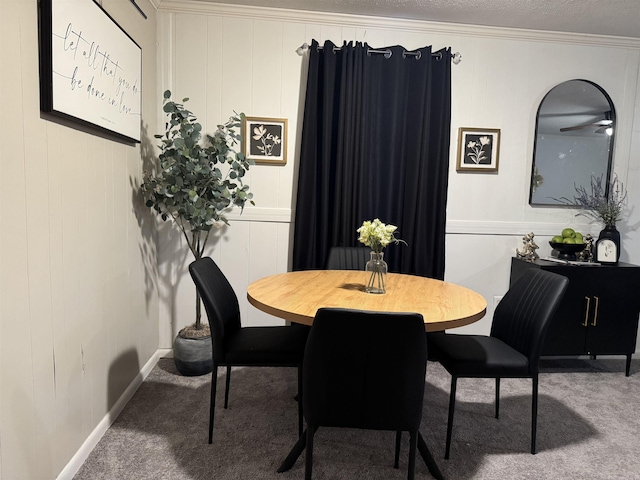 dining room with carpet flooring and crown molding