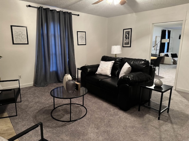 carpeted living area featuring ceiling fan, baseboards, and a textured ceiling