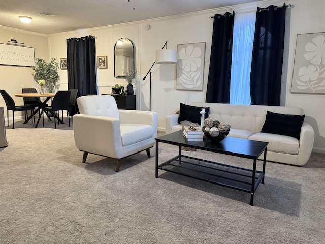 living area featuring carpet, baseboards, and crown molding