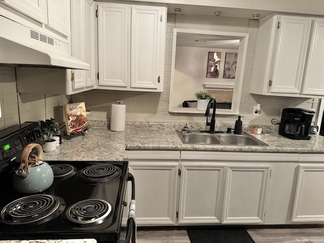 kitchen with black electric range, white cabinets, a sink, and under cabinet range hood