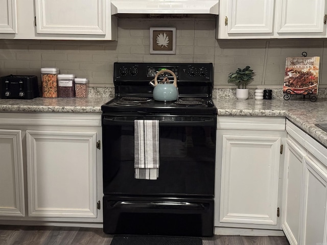 kitchen with black electric range, tasteful backsplash, light countertops, white cabinetry, and exhaust hood