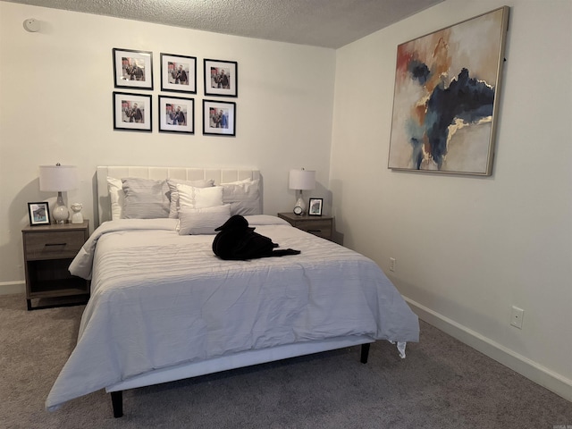 carpeted bedroom with baseboards and a textured ceiling