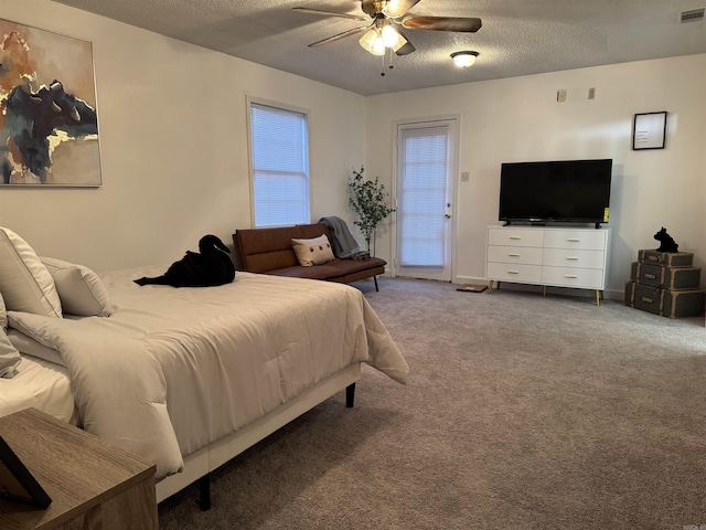 bedroom with carpet floors, access to exterior, a ceiling fan, and a textured ceiling