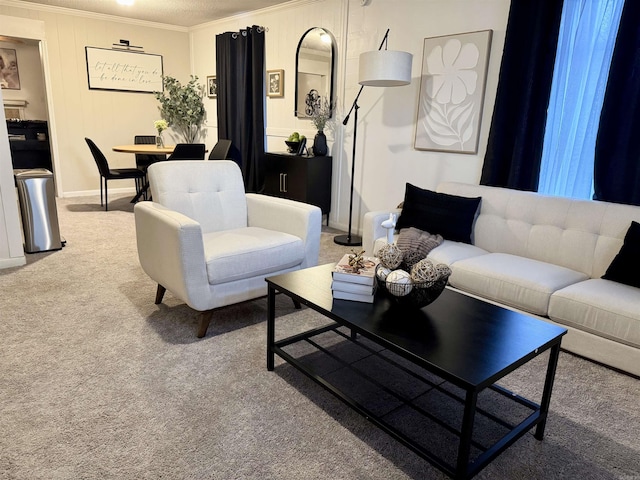 living area with baseboards, carpet floors, and crown molding