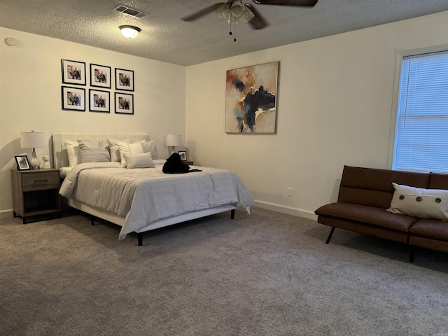 carpeted bedroom featuring visible vents, ceiling fan, a textured ceiling, and baseboards