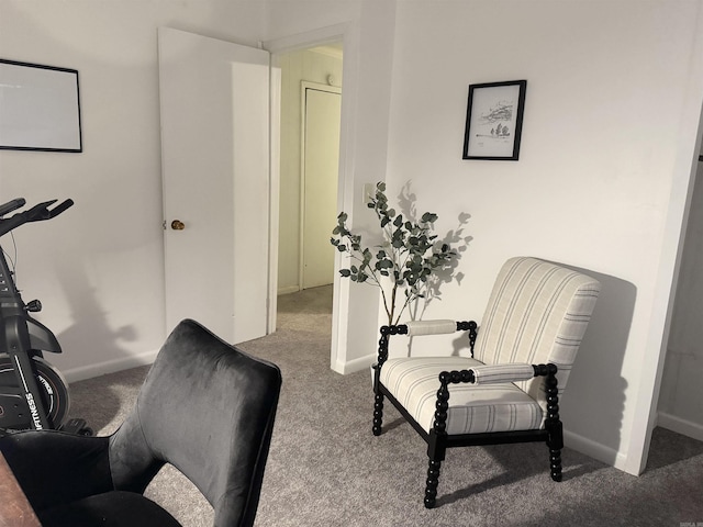 sitting room featuring carpet and baseboards