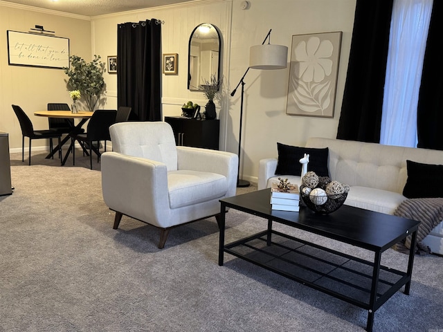 living area featuring carpet, baseboards, and crown molding