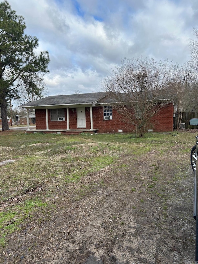 ranch-style home with brick siding and a front lawn