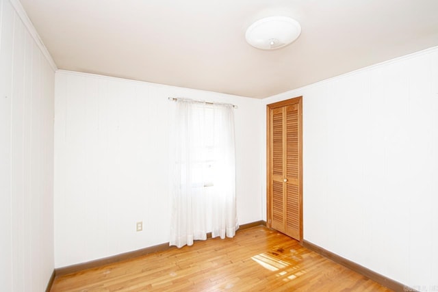 empty room with light wood-type flooring and baseboards