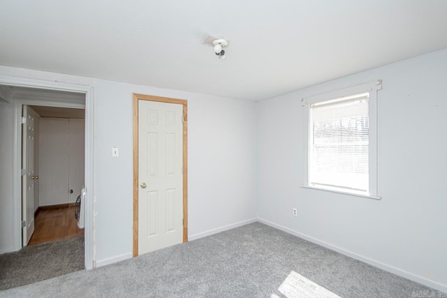 unfurnished bedroom featuring carpet flooring and baseboards